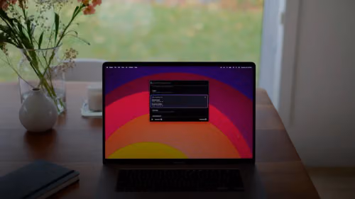 a laptop computer sitting on top of a wooden desk