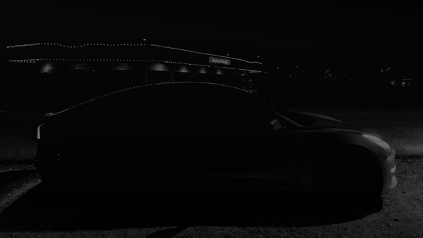red car on black asphalt road during night time