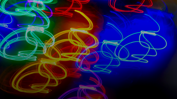 Abstract colorful light trails on dark background